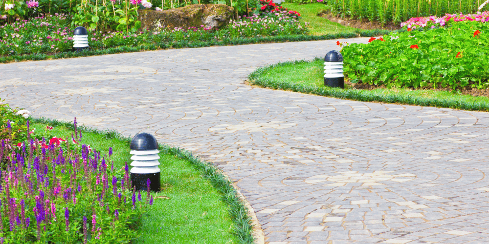 View of a clean and well maintained walkway to a home providing it with curb appeal